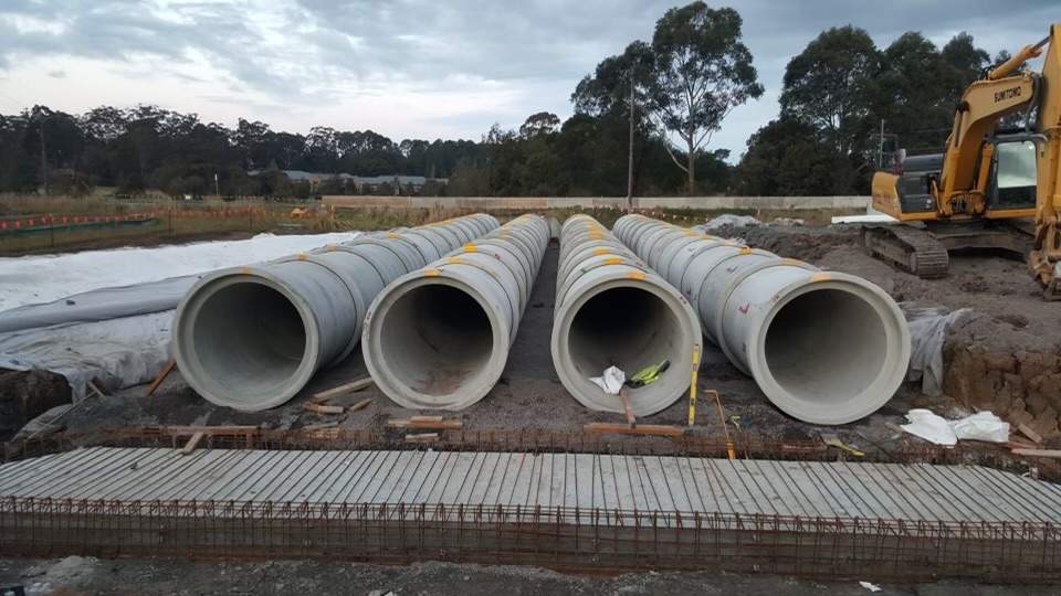 Rows of large diameter concrete pipes staged for installation